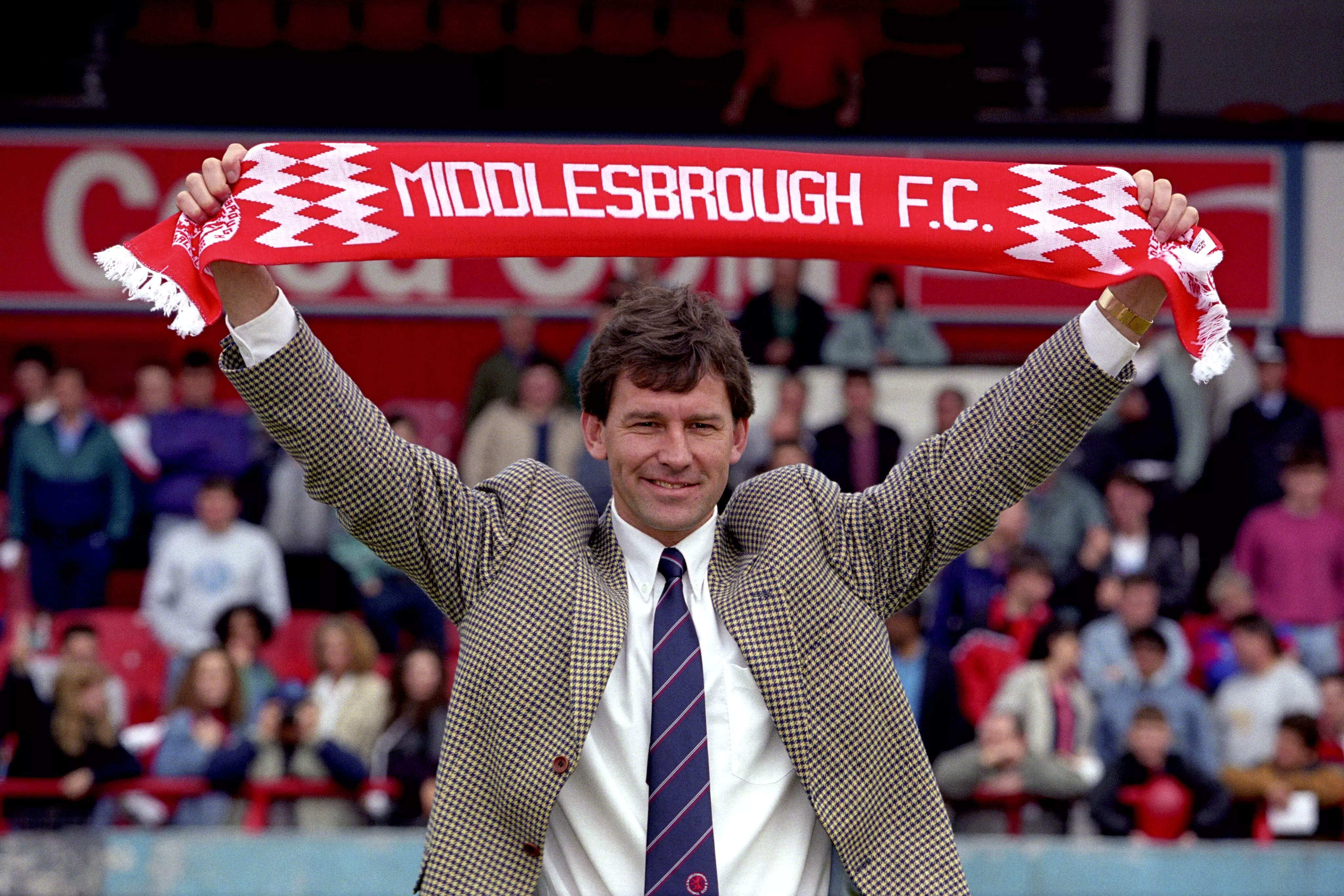 Bryan Robson holds up a scarf as he is unveiled as player-manager of Middlesbrough, May 1994