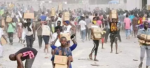 Breaking News: A group of Abuja residents have broken into a warehouse owned by the National Emergency Management Agency (NEMA) and have looted food items.